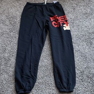 freecity navy blue sweatpants with red logo and cream accent